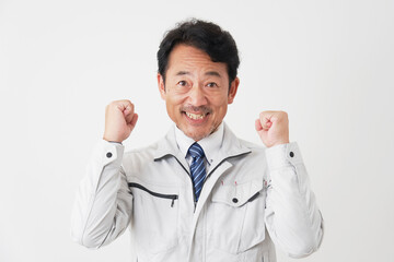 ガッツポーズをするミドルエイジの作業員　白背景