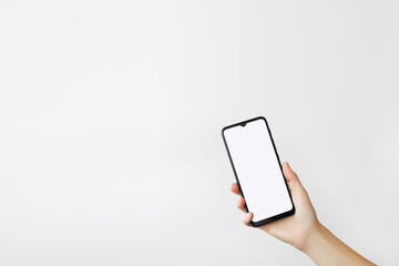 female hand holding smartphone with blank white screen on white background