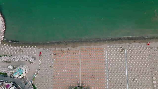 Aerial shot of a Caorle, the Resort sea beach city near to Venice. A beach at Adriatic Sea coastline in a sunset time