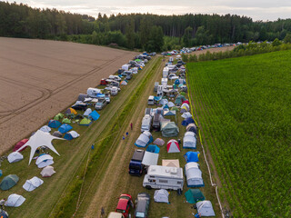 Aerial Drone Shot at Plenty of tents and Campers at a festival campsite. Camping Area Outdoors at Nature,a Open Air Fest