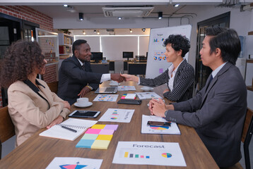 Black businessman handshaking with young woman  partner at meeting