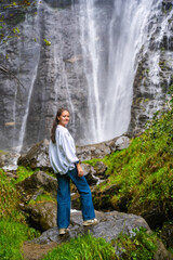 Naklejka na ściany i meble Young woman near waterfall in San Pietro town in Italy