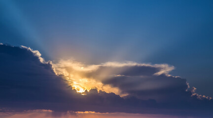 summer dawn, the sun cuts through the clouds in the early morning