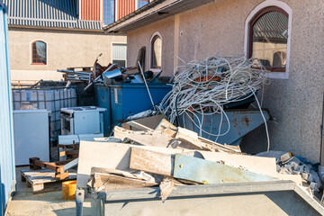 A lot of different garbage, construction debris, waste in big containers