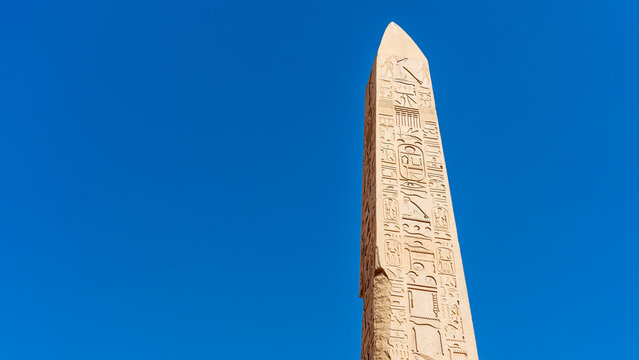 Obelisk of thutmose i set against a blue sky