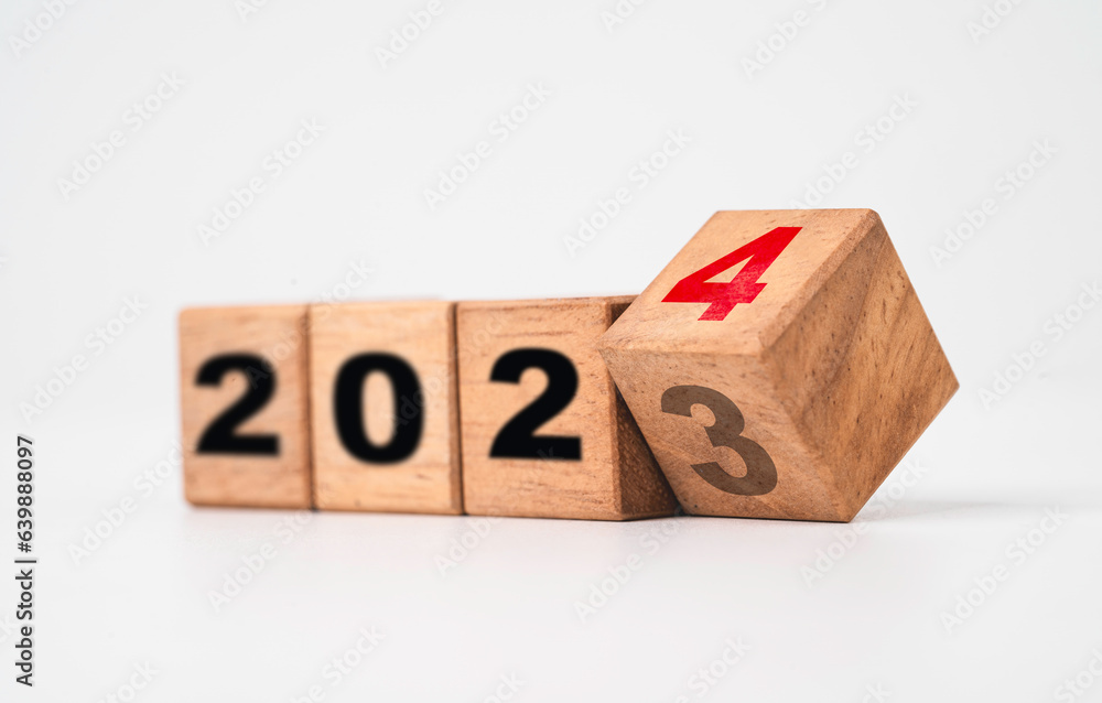 Poster flipping of 2023 to 2024 on wooden block cube for preparation merry christmas and happy new year cha