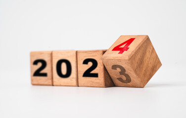 Flipping of 2023 to 2024 on wooden block cube for preparation merry Christmas and happy new year change and start new business target strategy concept. - obrazy, fototapety, plakaty