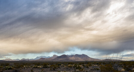 Fototapeta na wymiar Large Storm Breaks Up Over The Desert And Chisos Mountains In Big Bend