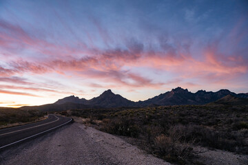 Light Pink Clouds Hang Over The Chisos Mountains At Sunrise