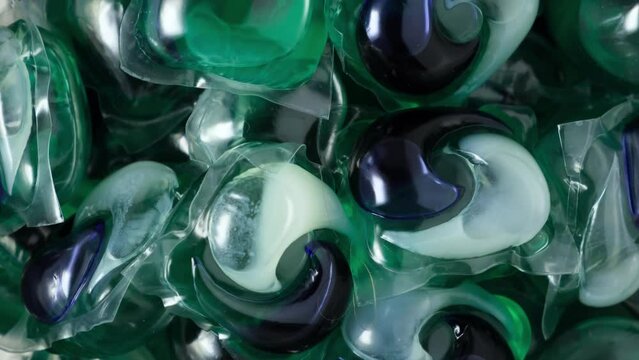 Laundry beads or Laundry gel capsules, close-up. Soluble capsules with synthetic detergent for washing clothes. 4K Video, Rotating.