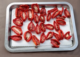 sliced,cut tomatoes halves for drying in hot sun light 