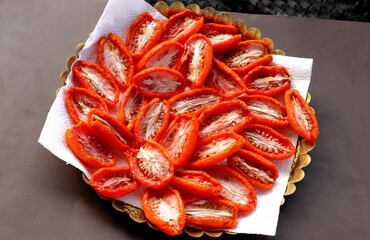 sliced,cut tomatoes halves for drying in hot sun light 