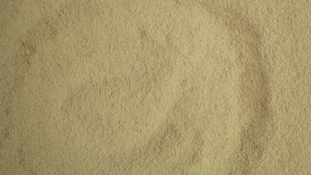 Texture of Maca Powder, close-up. Maca gelatinized flour. Peruvian superfood, natural organic supplement. 4K video, Rotating.