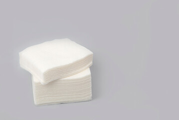 White paper napkins on a gray background. a stack of white napkins. Toilet hygiene products