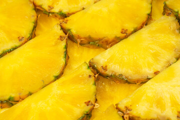 Pineapple juicy yellow slices as a background.