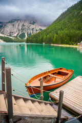 Traditional wooden rowing boat on scenic Lago di Braies in the Dolomites, South Tyrol, Italy