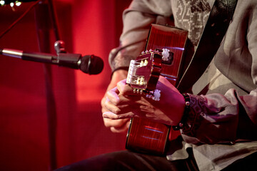 male hands playing acoustic guitar.