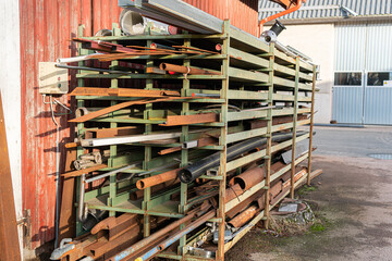 A lot of long metal rails, rakes, bars, strips, boards, poles of different shape