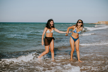 Two pretty young woman having fun on the seaside