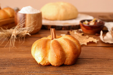 Fototapeta premium Tasty pumpkin shaped bun on table