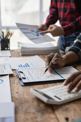 Young businessmen brainstorm meetings, discuss financial statistics together, multi-ethnic...