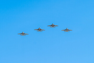 Formation of military jets flying in the clear blue sky during daylight