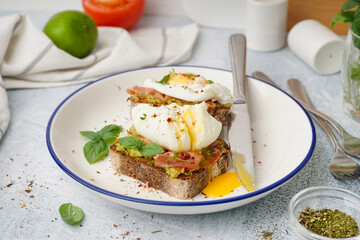 Plate of tasty sandwiches with egg on grey background