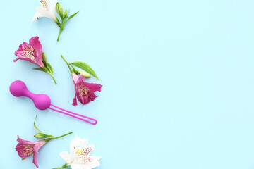 Beautiful alstroemeria flowers and anal plug on blue background