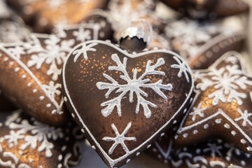 Christmas decorations in beautiful chocolate color with painted snowflakes in the shape of hearts