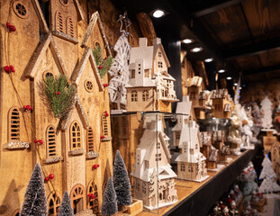 Christmas wooden houses stand in the street winter market