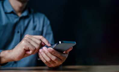 smart phone, close up, people, hand, businessman, portrait, showing, background, blue, equipment. picture is portrait close up to businessman, him hold smart phone and look fixedly at, then play it.