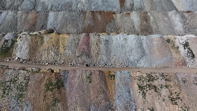 Aerial copper gold mine tailings Ely Nevada 4K slide. Boom town along historic Pony Express trail. Rural mining community. Ore transported to Japan for smelting. Precious minerals.