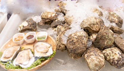Delicious fresh oysters on sale at stall. Street food and travel