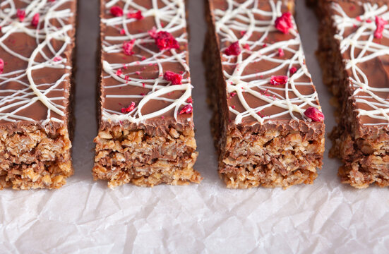 Simple Bars With Oatmeal And Brown And White Chocolate On Baking Paper