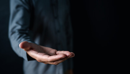 background, close up, people, hand, businessman, portrait, showing, equipment, blue, standing. picture is close up to businessman, him stand and show hand for invite something. equipment is dark blue.
