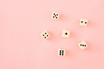 Wimple pattern or wallpaper with white and black gaming board game dice on bright pink background....