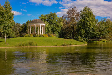 beautiful gazebo on the shore of the pond. landscape by the water