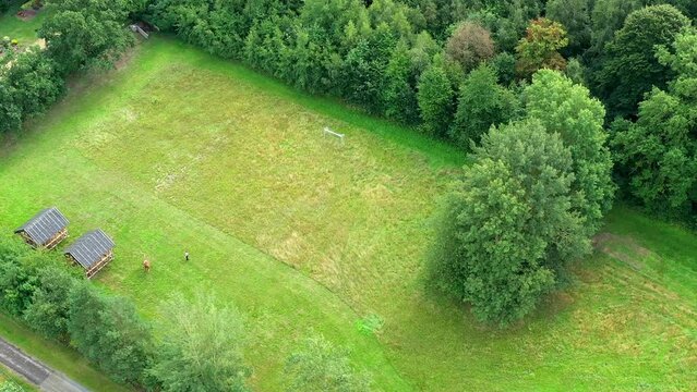 Aerial view of a well-maintained lawn used for exercises with vaulting horses