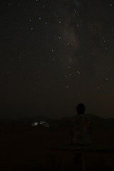 Flower shirt guy looking into the milky way on the Wadi Rum desert