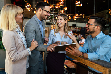 Multiracial business people, friends having fun, working and laughing drinking coffee in coffeehouse