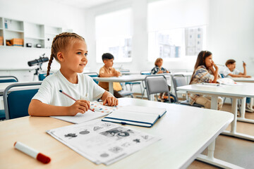 Fototapeta premium Children learning in a school classroom