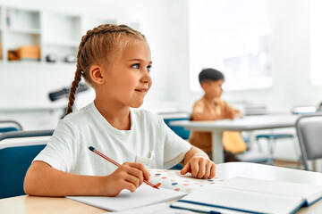 Fototapeta premium Children learning in a school classroom