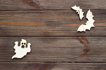 Wooden ghost toy on a wooden background, Halloween concept
