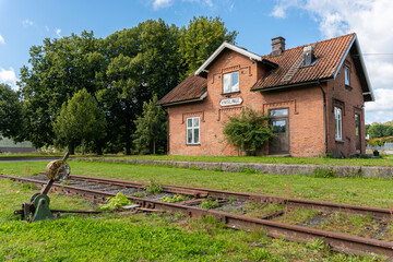 An old vintage private house from red bricks in front of abandoned railway station in Knislinge, Sweden