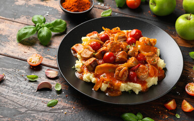 Devilled Sausages with mashed potato, spiced tomato and apple sauce.