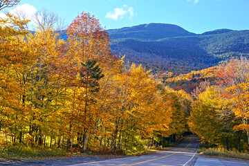 Autumn colors at the start of Smuggler's Notch with Mount Mansfield behind, Vermont, USA