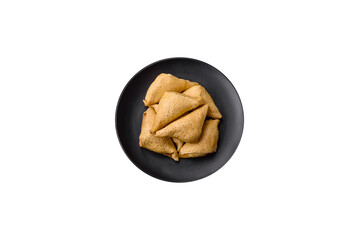 Delicious pancakes triangular shape with meat, salt and spices