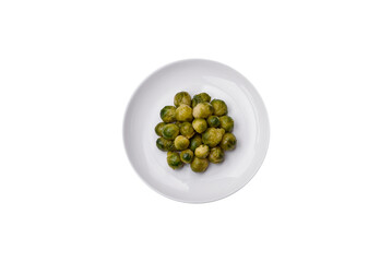 Delicious boiled Brussels sprouts on a ceramic plate on a dark concrete background