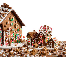 Christmas gingerbread house decorated with sweets on a white background. Generative AI