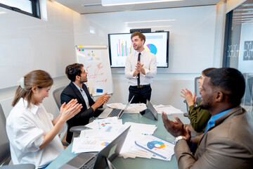 Caucasian manager stand in front of meeting room to express happiness about the success of their...